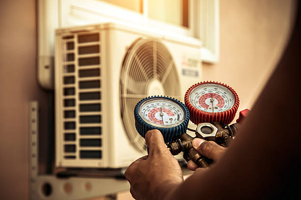 Professional Air Conditioning Service technician working in Harvey, MI